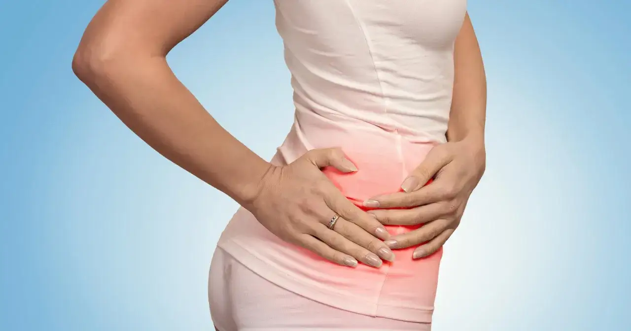 Kobieta odczuwa tępy ból w prawym boku nad biodrem, co sugeruje dyskomfort w tej okolicy.